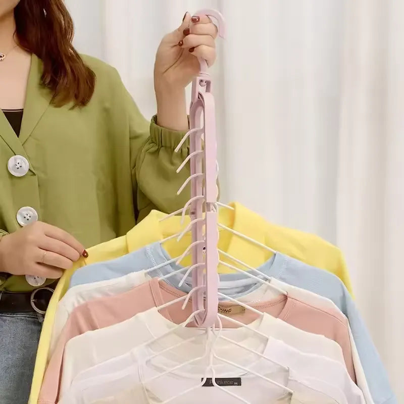 Woman holding Magic Hanger vertically with multiple shirts organized